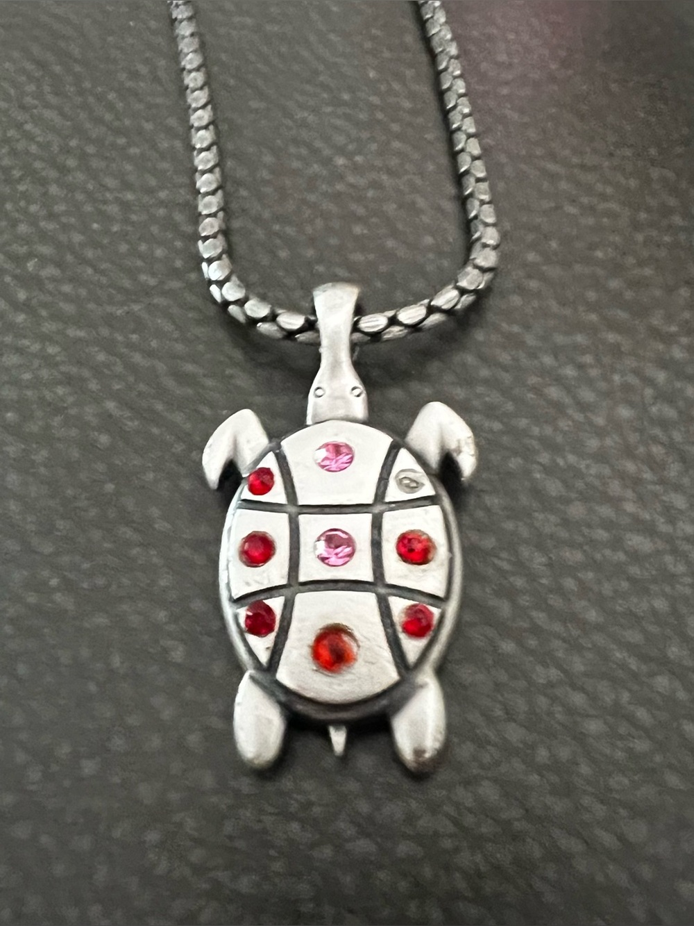 Silver tone Turtle Pendant Necklace with Red and Pink Accent Stones.